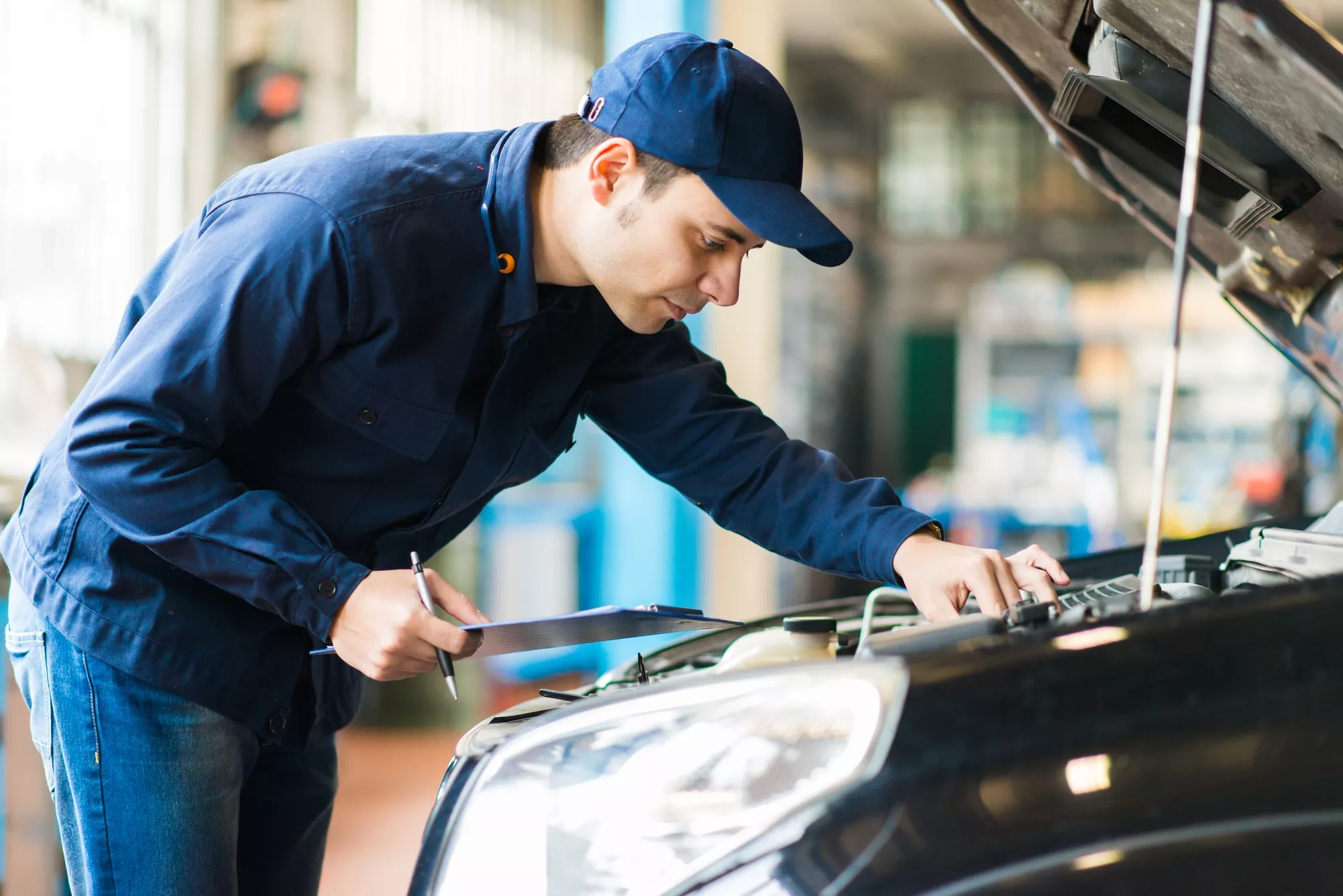 mechanic inspecting car
