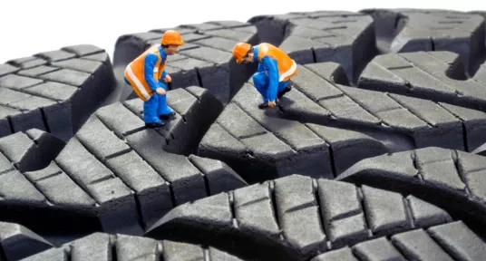 Man inspecting tyre