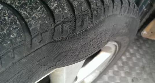 Tyre showing damage and bulging